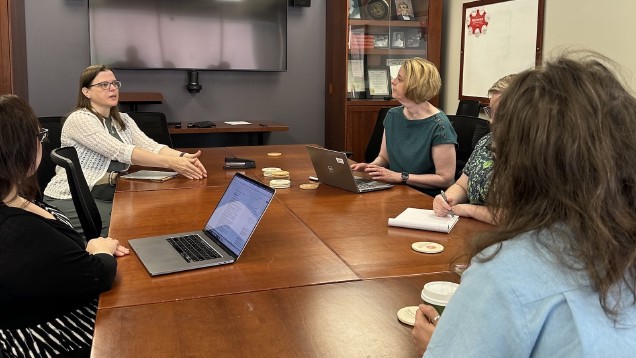 people sitting around a conference table having a conversation