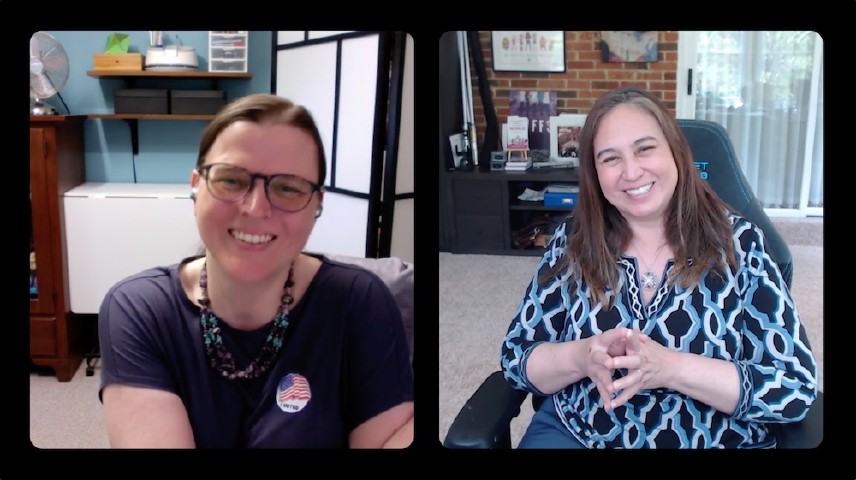 Two women smiling in a web meeting.